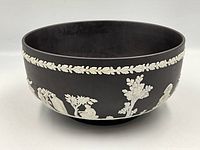Front view of black jasperware bowl with white relief frieze