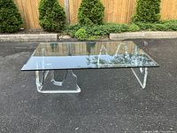 Front view of coffee table showing full glass top and lucite base