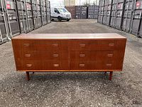 Full front view of dresser showing six drawers and four legs