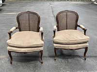 Front view of both chairs showing cane backs and upholstered seats