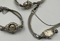 Three watches arranged on table showing overall lot