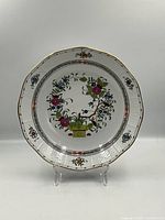 Front view of the bowl showing the floral basket pattern and scalloped rim with gold accents.