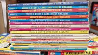 Stack of Archie comic digest magazines showing various issues mainly from 'Archie's Story & Game Comic Digest Magazine' series with colorful spines and numbered labels.