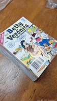 Stack of 16 Betty and Veronica Digest Comic Books showing the front cover of top comic with characters in summer clothes and picnic scene.