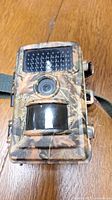 Front view of CamPak T40 trail camera showing camo exterior, lens, motion sensor, and infrared LED array.