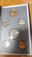 Top view of six Canadian coins displayed in foam holder inside specimen set case.