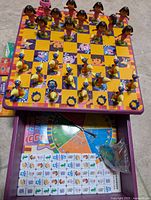 Top view of multi game table with all checkers pieces set, Dora and Boots characters on the board