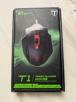 Box front showing Easterntimes Tech T1 Wired Gaming Mouse with branding and features such as DPI control, weights, and side buttons.