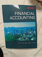 Front cover of Financial Accounting textbook showing the cityscape and title with author names.