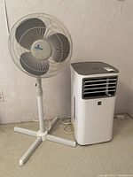 Photo showing both the Kenmore portable air conditioner and Ocean Breeze fan side by side on the floor.