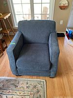 Front view of the blue Agnes chair showing cushioned seat and fabric upholstery.
