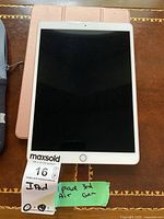Front view of iPad Air 3rd generation model A2152 with screen off and home button visible. A Maxsold label with notes indicating 'iPad 3rd Air Gen' is attached.