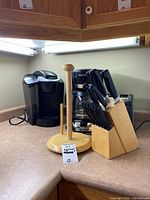 Keurig coffee maker, Henckels knife block set, wooden paper towel holder, Black & Decker coffee maker, toaster on kitchen countertop