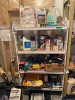 Overall view of shelf with paints, solvents, cleaners, sanding and painting tools