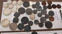 Full assortment of vintage Netherland coins on white background, multiple denominations and years visible