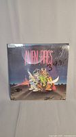 Front view of sealed Alien Fires: 2199AD game showing cartoon characters and game title