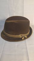 Front view of the brown felt fedora hat showing the soft velvety material and the folded brim.