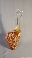 Full view of the amber and white glass giraffe sculpture showing body shape and pattern.