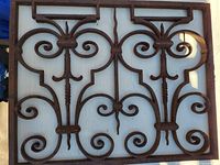 Full view of the cast iron security grill showing Gothic and Art Nouveau influenced scrollwork and design.