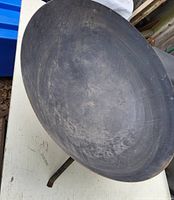 Top view of the steel fire pit bowl showing the interior surface with signs of wear.