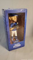Front view of the boxed Marco Estrada bobblehead showing clear plastic window and player figure.