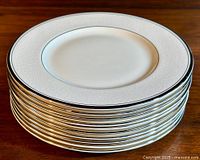 Stack of 10 Minton's 'Bridal Veil' salad plates showing silver trimmed edges and embossed floral pattern.