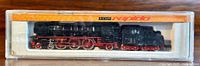 View of Arnold Rapido 4-6-2 steam locomotive and tender in original clear plastic case with orange and yellow branded insert.