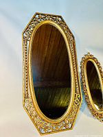 Large octagonal Syroco gilded mirror with ornate openwork frame and oval mirror glass