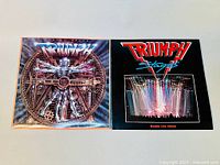 Front view of two vinyl LP album covers side by side. Left is 'Thunder Seven' with mechanical human design and blue tones. Right is 'Stages' double album with band name and live concert photo.