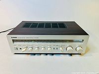 Full front view of Yamaha Natural Sound Stereo Receiver CR-240 with wooden top and metal front panel showing all controls and dials.