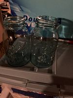 Two Ball Perfect Mason quart jars visible on a surface, clear view of glass and embossing details