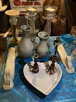 Overview showing all candlesticks and vases arranged on table.