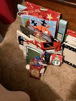 Photo of assorted Christmas gift bags upright, designs include reindeer, stars, snowflakes, and festive patterns.