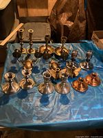 Full overview of 12 vintage candle holders in brass and metal finishes including butterfly motif holders