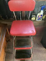 Full chair showing red vinyl seat and backrest, metal frame, two footrest steps with COSCO branding.