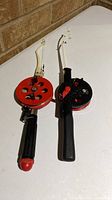 Two ice fishing rod-reel combos side by side