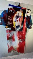 Front view of packaged butcher costume set hanging on door