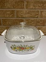 Front view showing vegetable motif and glass lid