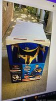 Sealed retail box showing Dynacraft Paw Patrol Chase ride-on inside