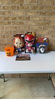 Full lot on table showing all five packaged items and pumpkin pail