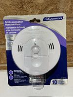 Front view of sealed Garrison smoke and CO alarm packaging