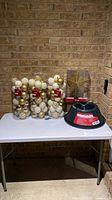 Full lot: three ornament cylinders, boxed star topper, wrapped tree stand