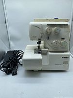 Left/front view of Kenmore serger with pedal cord visible