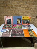 All nine LPs laid out on table showing front covers
