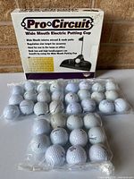Putting cup box, sealed putting cup, four bags of golf balls