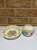 Porridge bowl and round coin bank front view