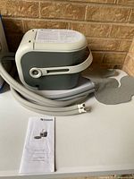 Main unit with hoses, knee pad and manual shown