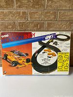 Front of Tyco Molson Indy slot car set box showing artwork of two race cars and track layout