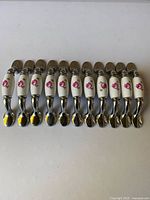 All 11 pulls aligned showing ceramic centers and metal ends