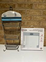 Zenna Home shower caddy beside boxed Taylor scale